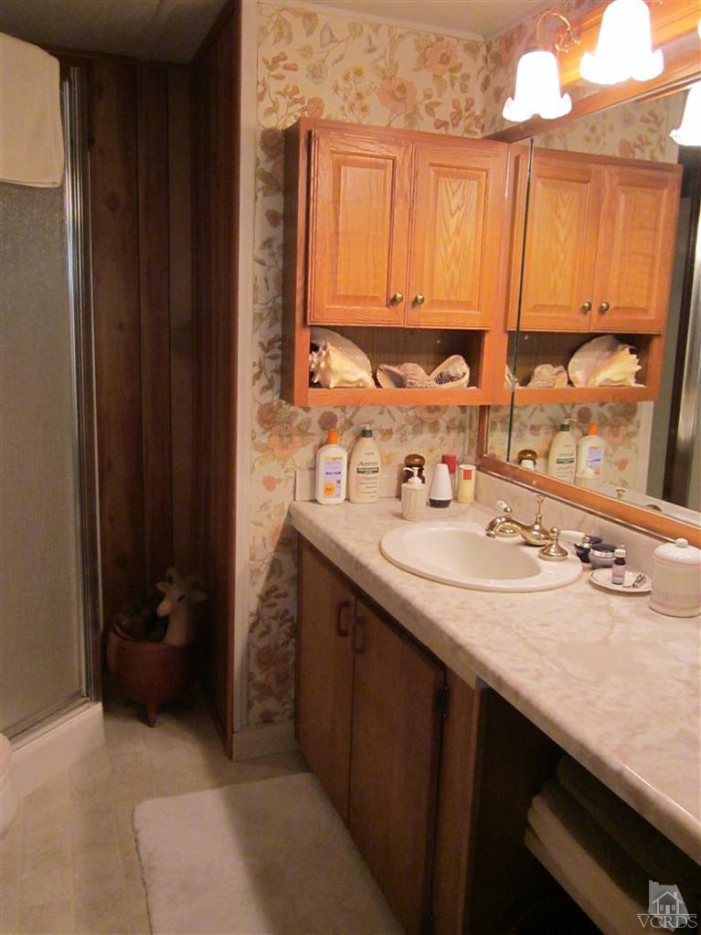 1225 South Rice Road, Unit 72 Ojai, CA 93023 - Photo 5 of 9 a bathroom with a sink and a mirror