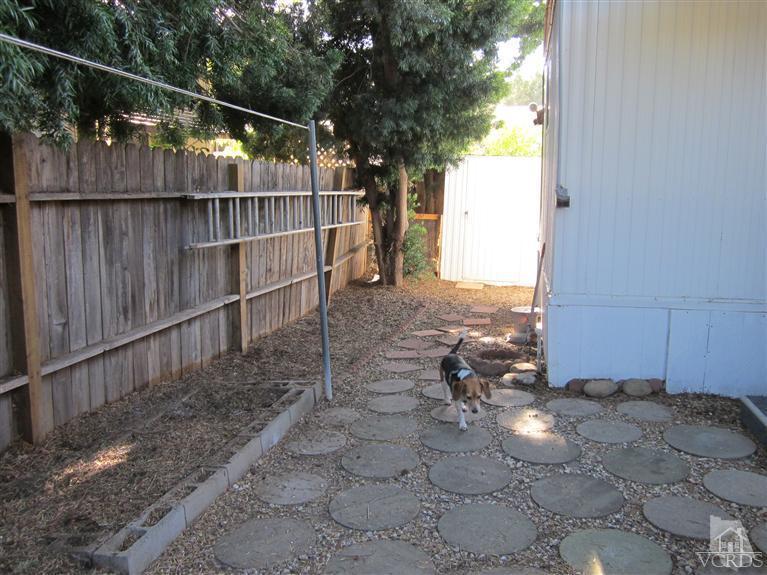1225 South Rice Road, Unit 72 Ojai, CA 93023 - Photo 8 of 9 a view of a yard with wooden fence and a bench