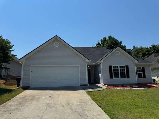 3509 Woodruff Ridge Lane Southwest Loganville, GA 30052 - Photo 1 of 1 a front view of a house with a garden and yard