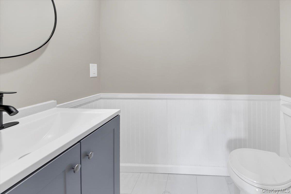 34 Kings Ferry Road Montrose, NY 10548 - Photo 26 of 36 Bathroom with vanity, wainscoting, and light tile patterned floors