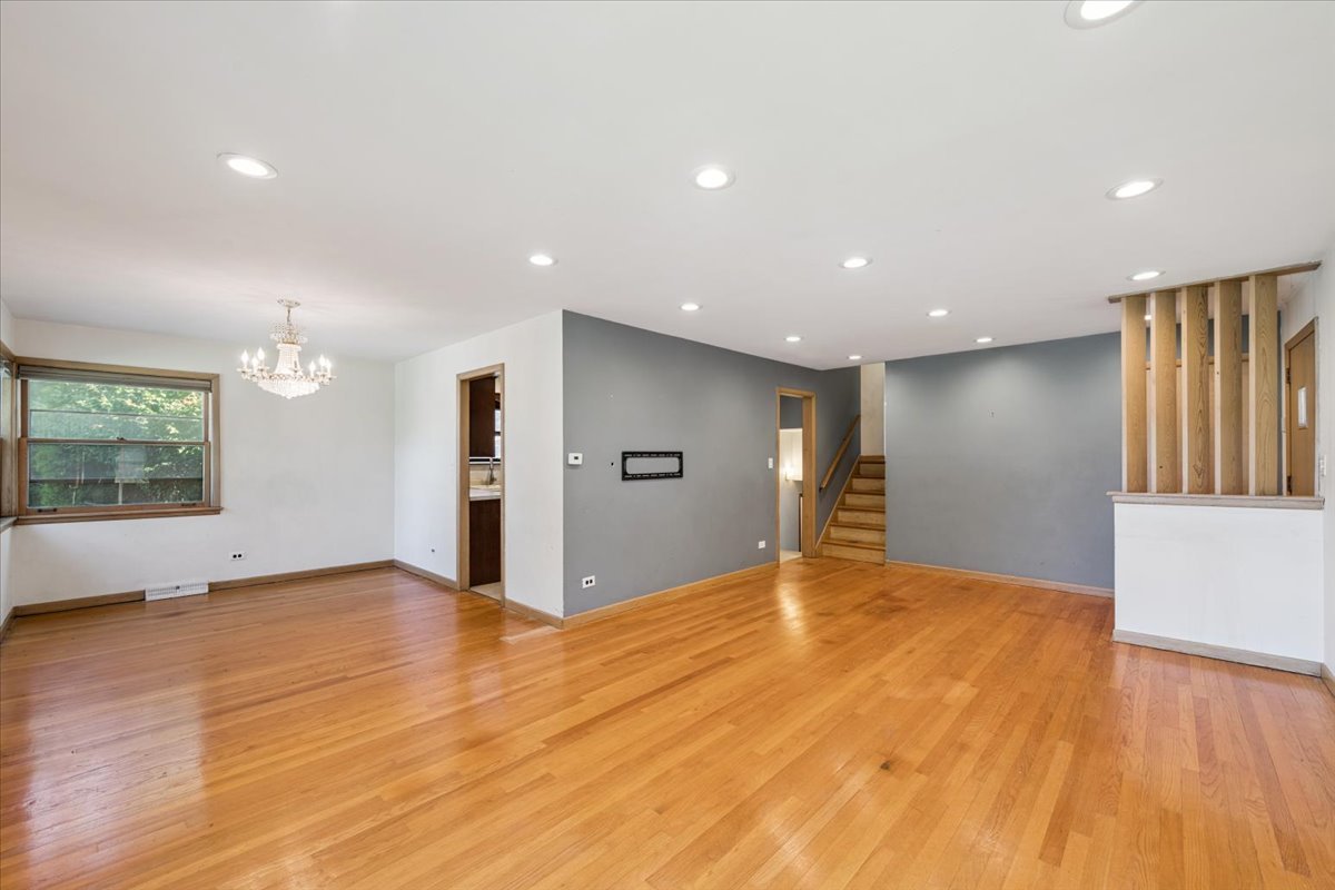 1009 South Washington Avenue Park Ridge, IL 60068 - Photo 2 of 24 a view of an empty room with wooden floor and a window