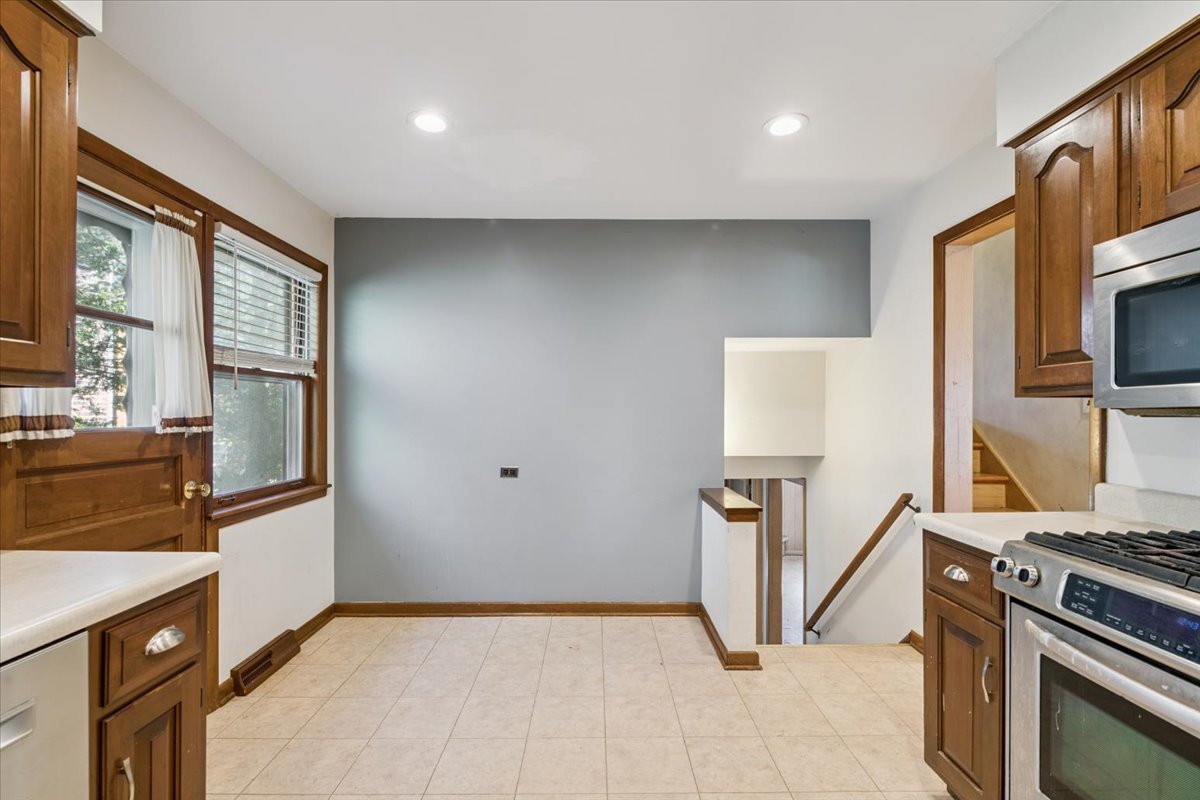 1009 South Washington Avenue Park Ridge, IL 60068 - Photo 7 of 24 a kitchen with stainless steel appliances granite countertop a refrigerator stove and sink