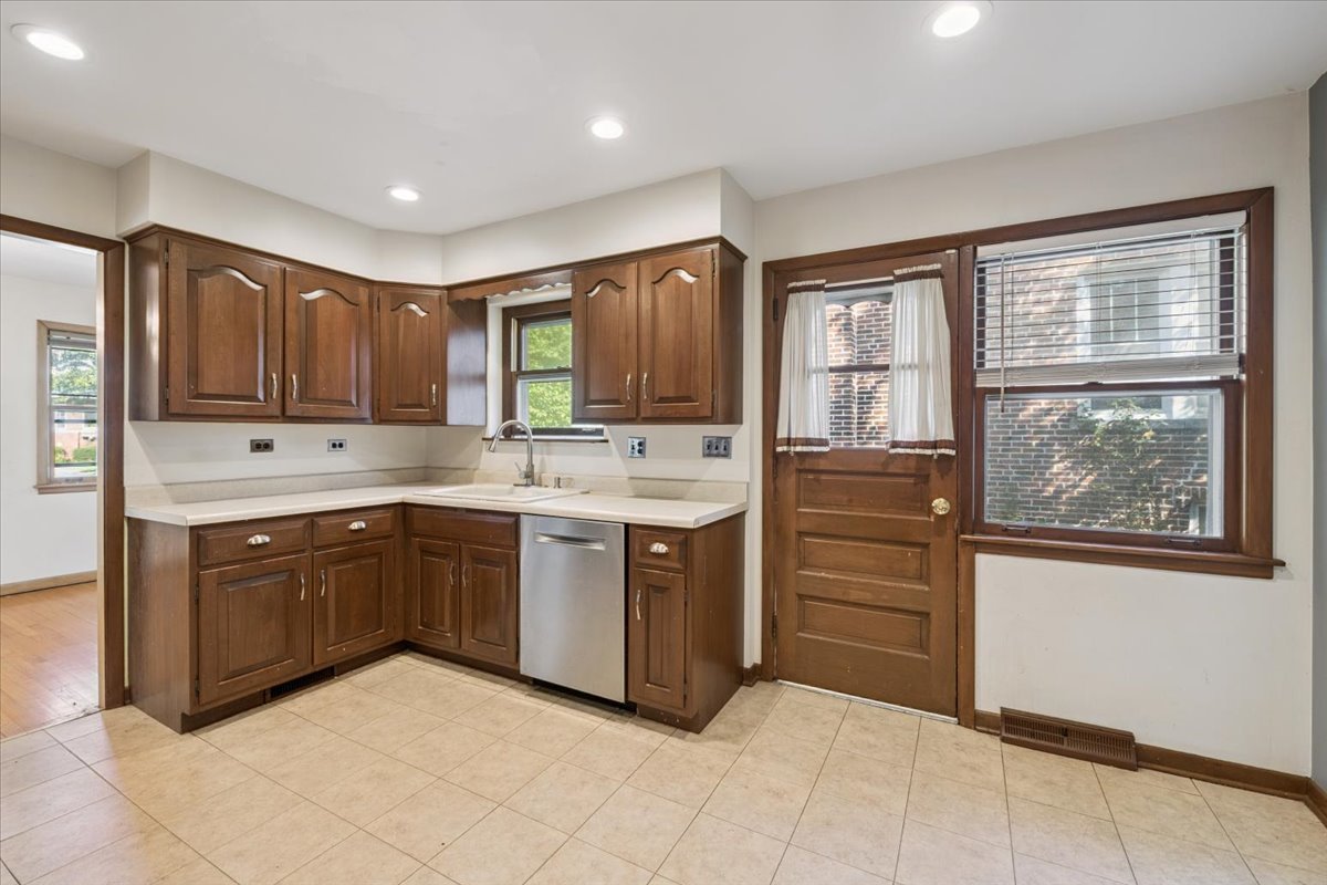 1009 South Washington Avenue Park Ridge, IL 60068 - Photo 8 of 24 a kitchen with stainless steel appliances granite countertop a stove sink and cabinets