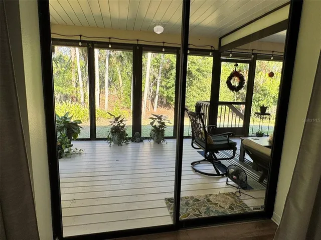 a view of a livingroom with wooden floor and furniture