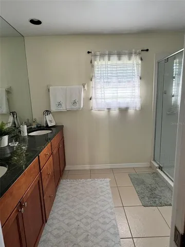 a kitchen with granite countertop a sink a stove and a refrigerator