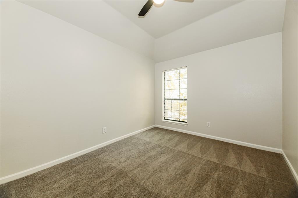 813 Ridgemont Drive Allen, TX 75002 - Photo 21 of 27 Carpeted empty room featuring lofted ceiling and ceiling fan