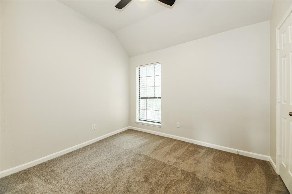 813 Ridgemont Drive Allen, TX 75002 - Photo 22 of 27 Spare room featuring carpet floors, a ceiling fan, and lofted ceiling
