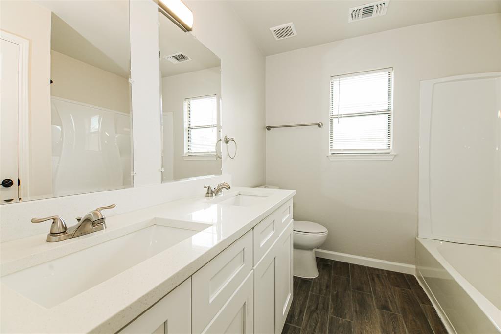 813 Ridgemont Drive Allen, TX 75002 - Photo 24 of 27 Bathroom with double vanity and wood finished floors