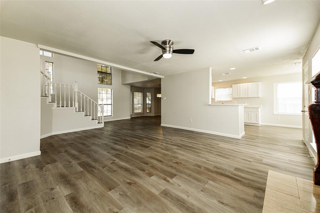 813 Ridgemont Drive Allen, TX 75002 - Photo 6 of 27 Unfurnished living room featuring a ceiling fan, stairs, wood finished floors, and recessed lighting