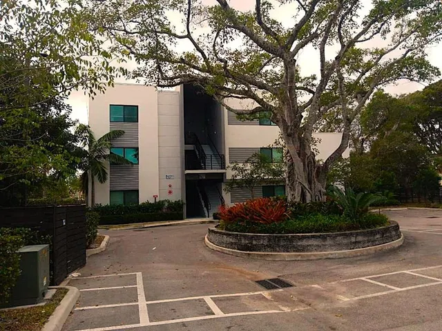 a view of white house with a yard