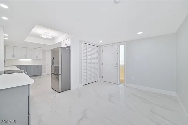 a bedroom with a bed and large window