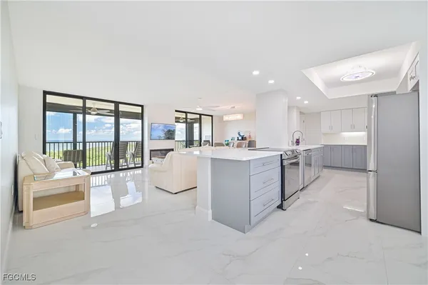 a room with white cabinets and white appliances