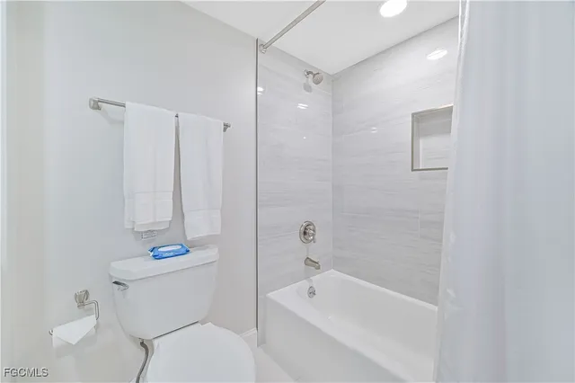 a bed room with a bed and a television