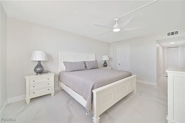 a bathroom with a granite countertop sink toilet and a mirror