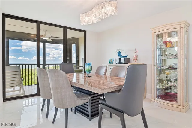 a view of a dining room with furniture large windows and wooden floor
