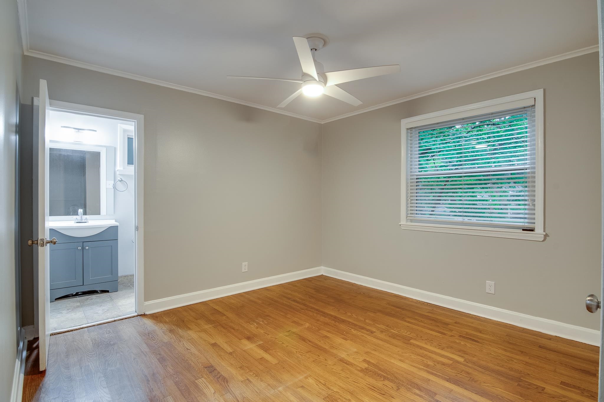 4970 Sequoia Road Memphis, TN 38117 - Photo 13 of 31 a view of an empty room with wooden floor and a window