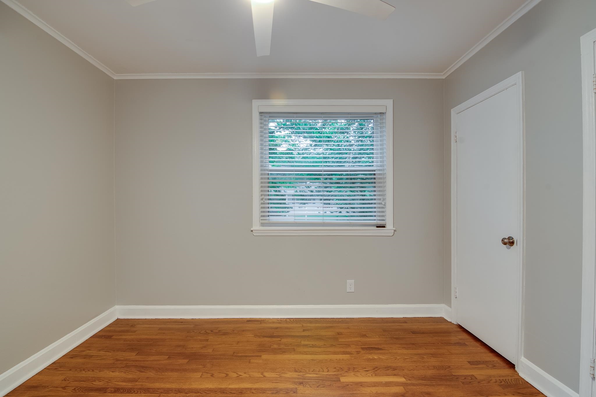 4970 Sequoia Road Memphis, TN 38117 - Photo 14 of 31 a view of an empty room with wooden floor and a window