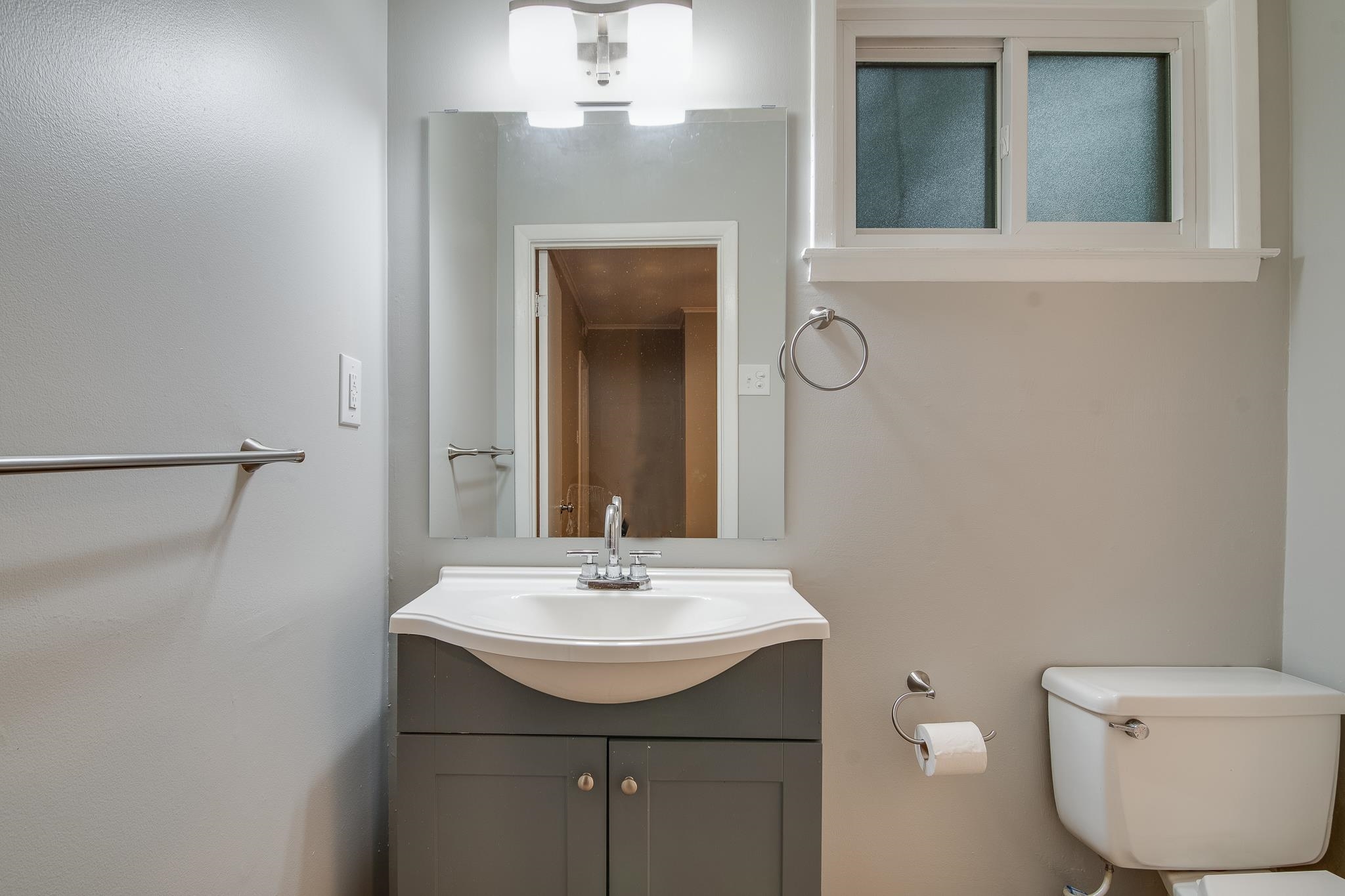 4970 Sequoia Road Memphis, TN 38117 - Photo 17 of 31 a bathroom with a toilet sink and mirror