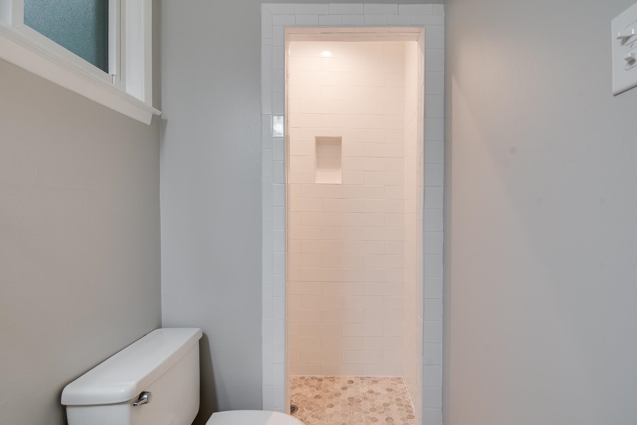 4970 Sequoia Road Memphis, TN 38117 - Photo 18 of 31 a white toilet sitting next to a shower