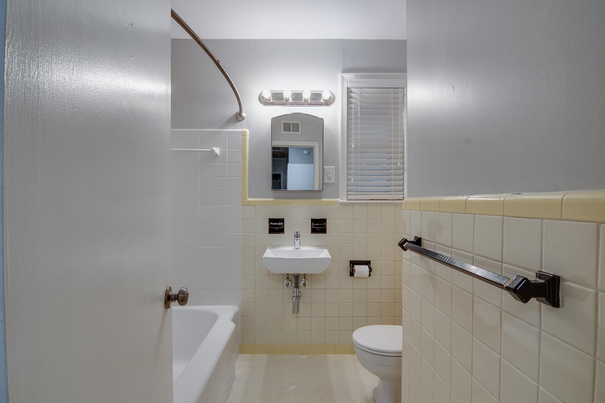 4970 Sequoia Road Memphis, TN 38117 - Photo 21 of 31 a bathroom with a sink a toilet a mirror and shower