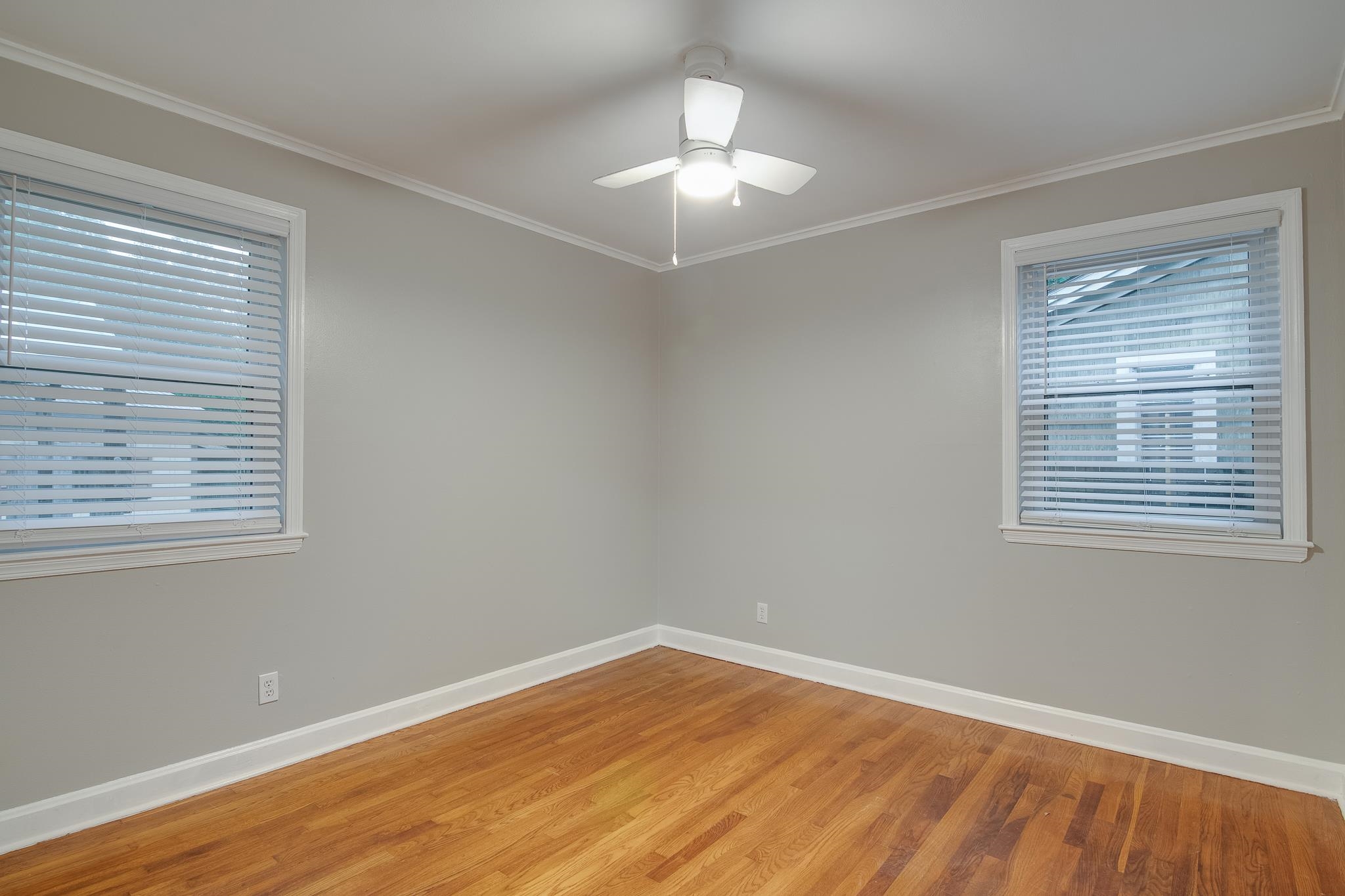4970 Sequoia Road Memphis, TN 38117 - Photo 23 of 31 a view of an empty room with wooden floor and a window