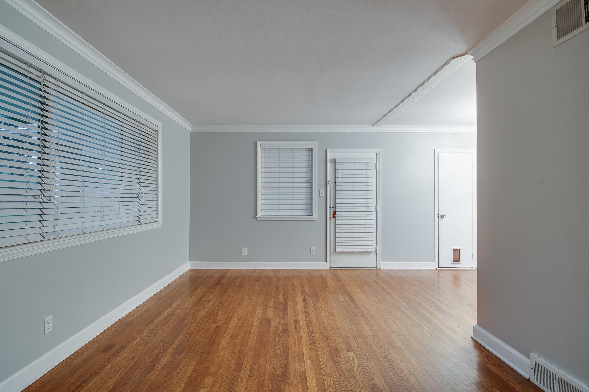 4970 Sequoia Road Memphis, TN 38117 - Photo 4 of 31 an empty room with wooden floor and windows