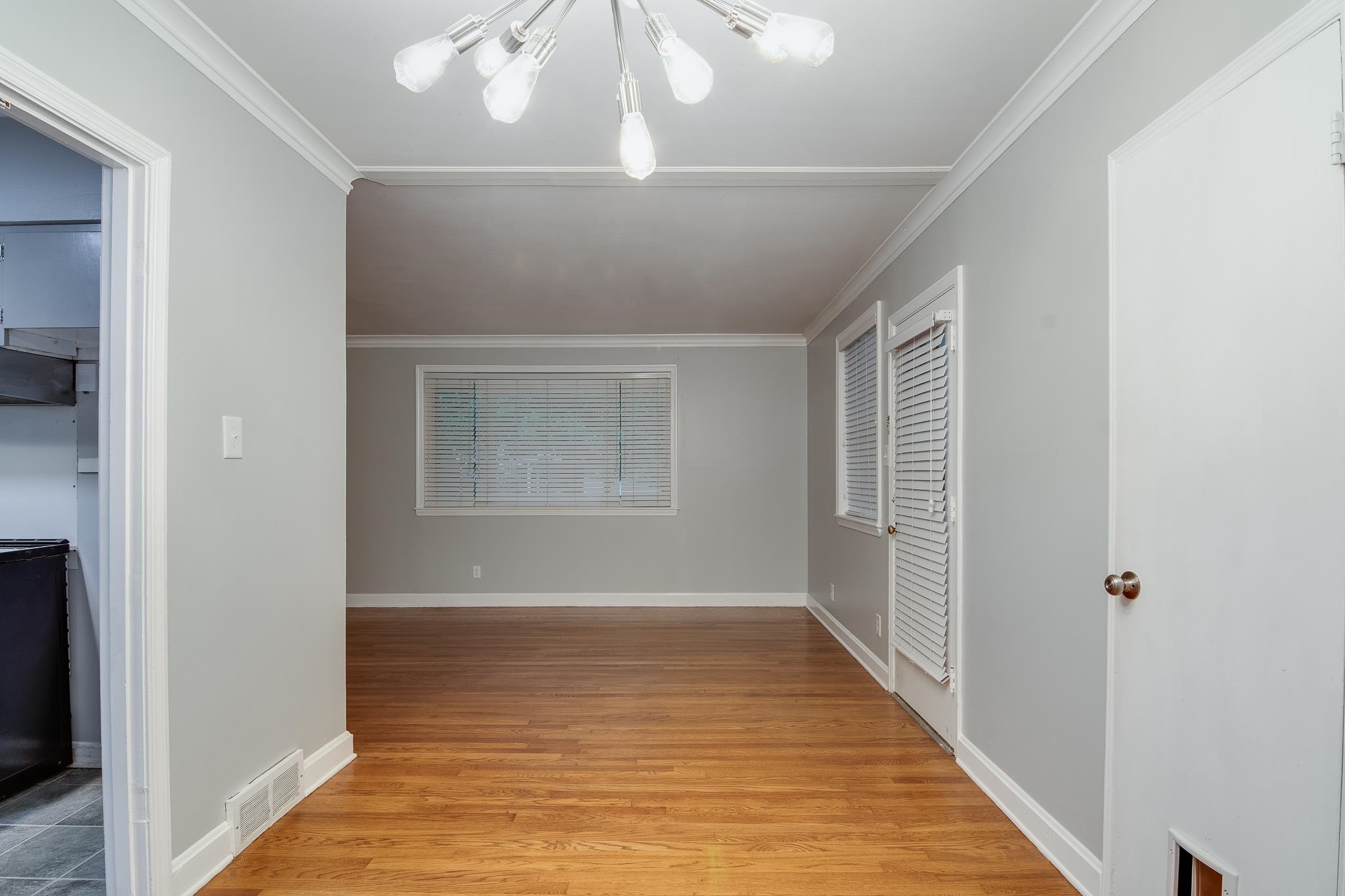 4970 Sequoia Road Memphis, TN 38117 - Photo 8 of 31 a view of an empty room with wooden floor and a window