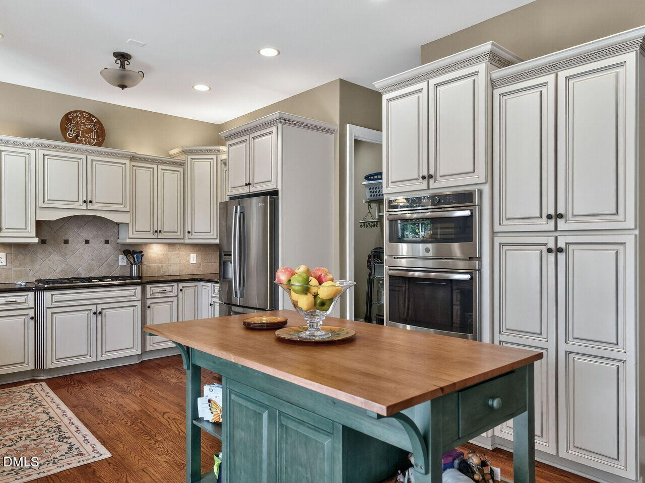 10312 Old Creedmoor Road Raleigh, NC 27613 - Photo 13 of 40 a kitchen with refrigerator cabinets and stove