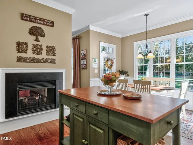 a kitchen with a table chairs and a fireplace