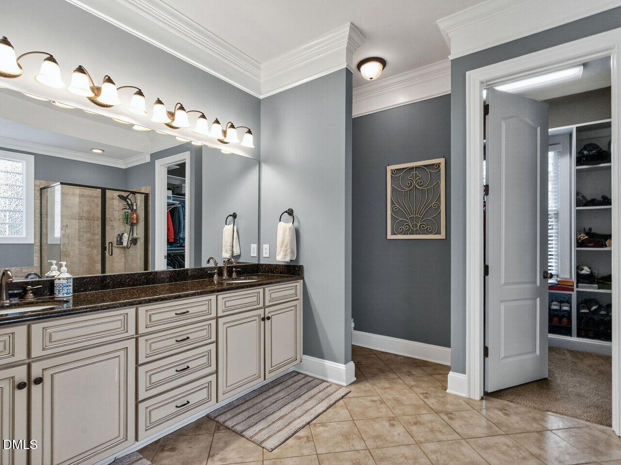 10312 Old Creedmoor Road Raleigh, NC 27613 - Photo 17 of 40 a spacious bathroom with a granite countertop sink a mirror and a