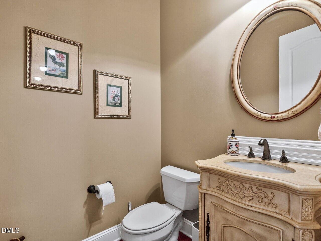 10312 Old Creedmoor Road Raleigh, NC 27613 - Photo 19 of 40 a bathroom with a granite countertop toilet a sink and a mirror
