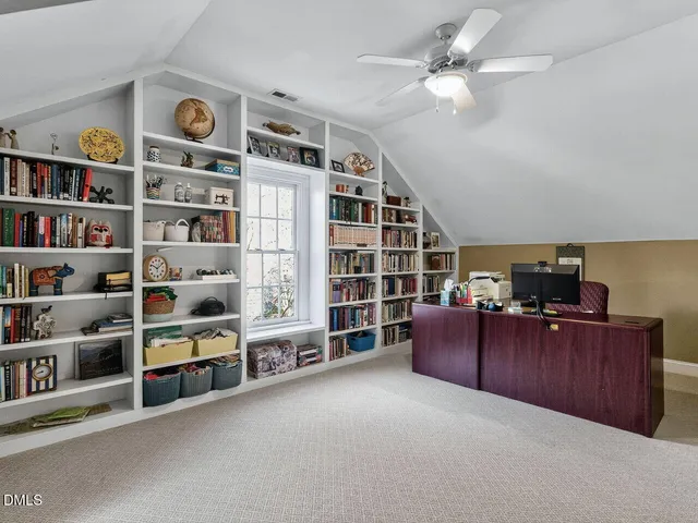 a living room with furniture and a bookshelf