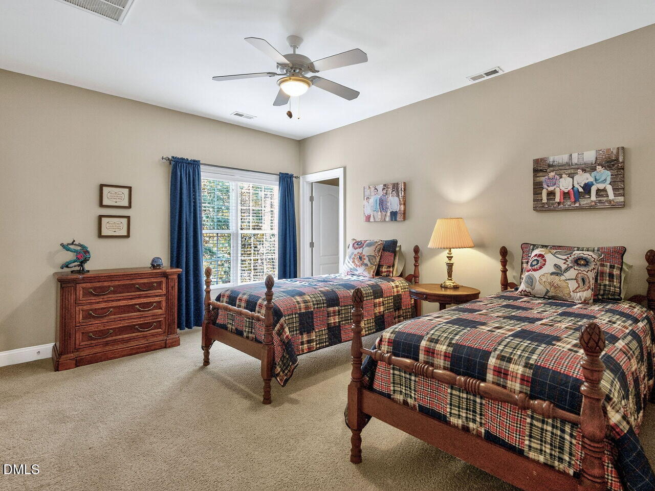 10312 Old Creedmoor Road Raleigh, NC 27613 - Photo 25 of 40 a spacious bedroom with two beds and a chandelier