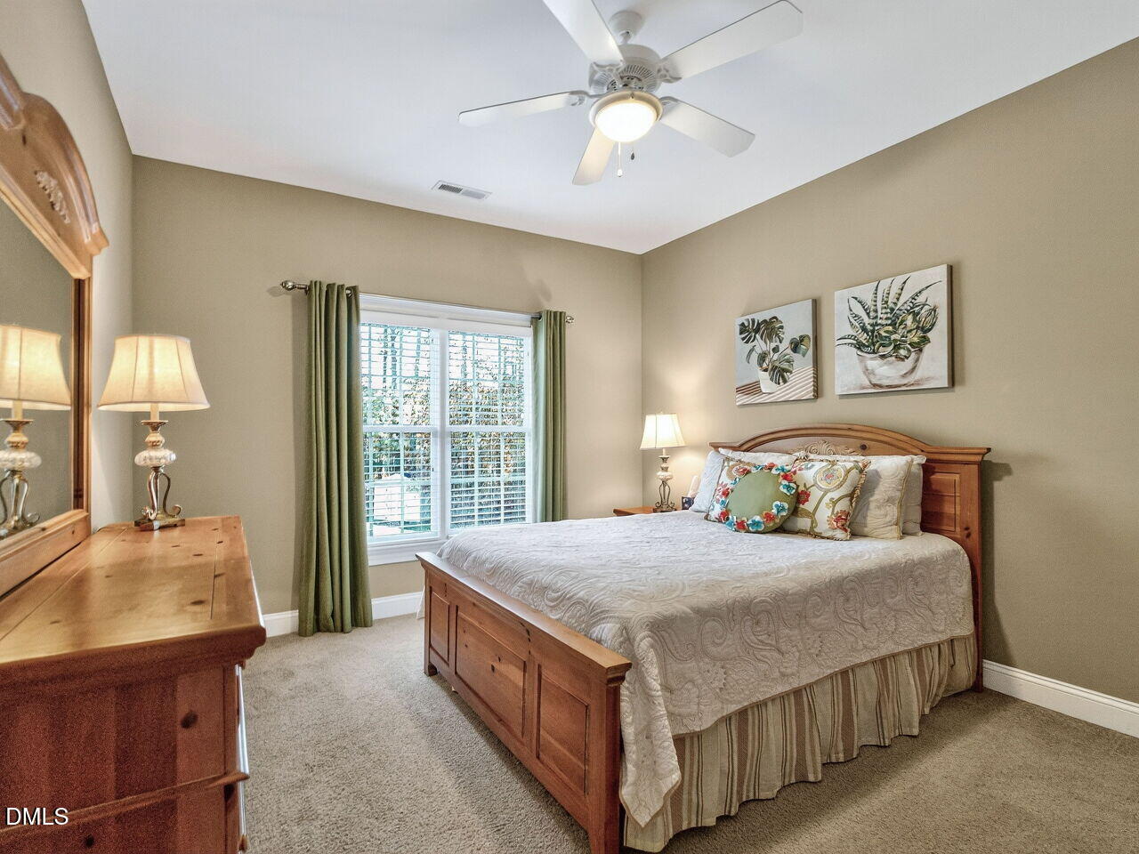 10312 Old Creedmoor Road Raleigh, NC 27613 - Photo 28 of 40 a bedroom with a large bed and a chandelier