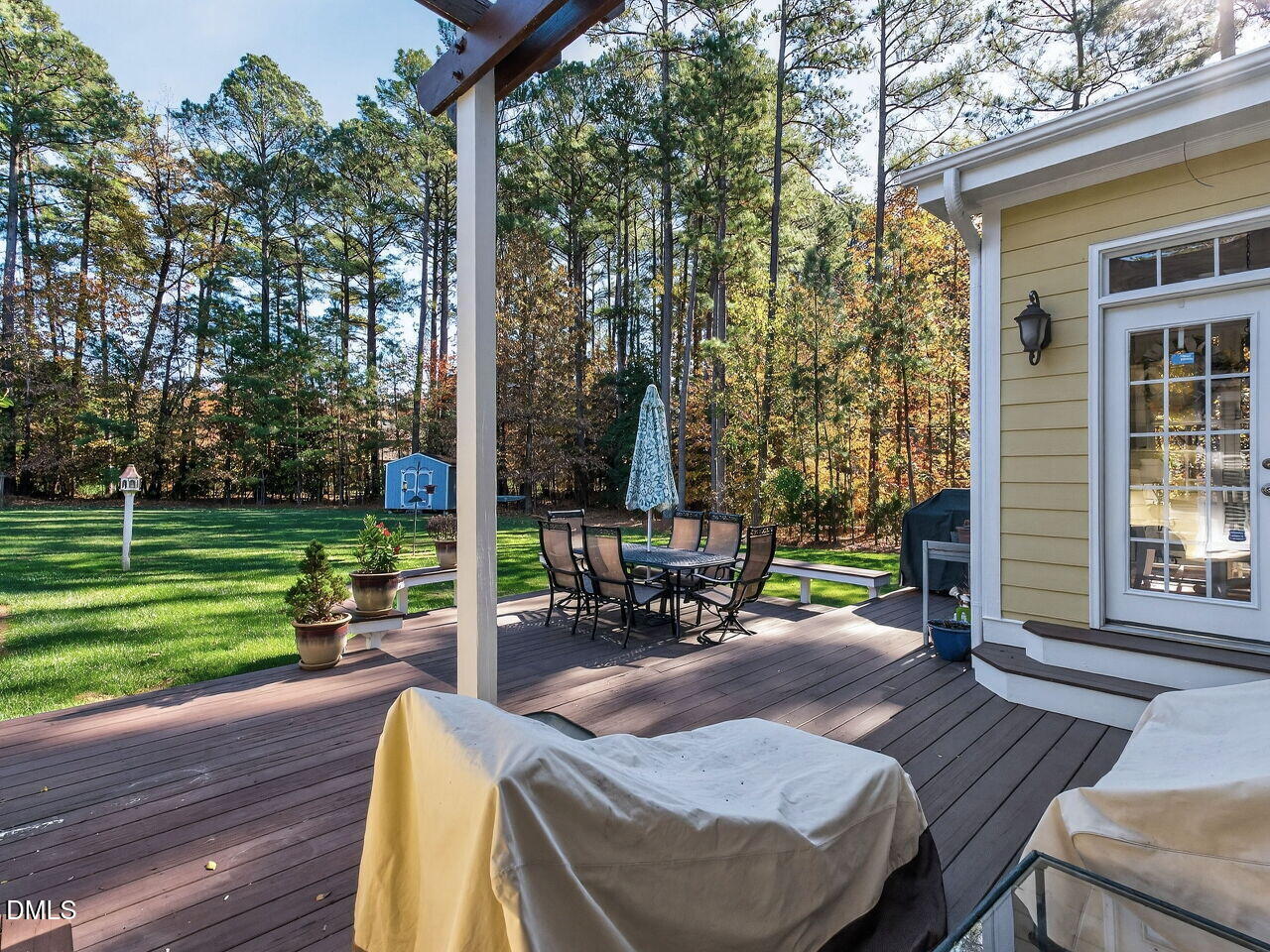 10312 Old Creedmoor Road Raleigh, NC 27613 - Photo 33 of 40 a view of a patio with table and chairs with wooden floor and fence