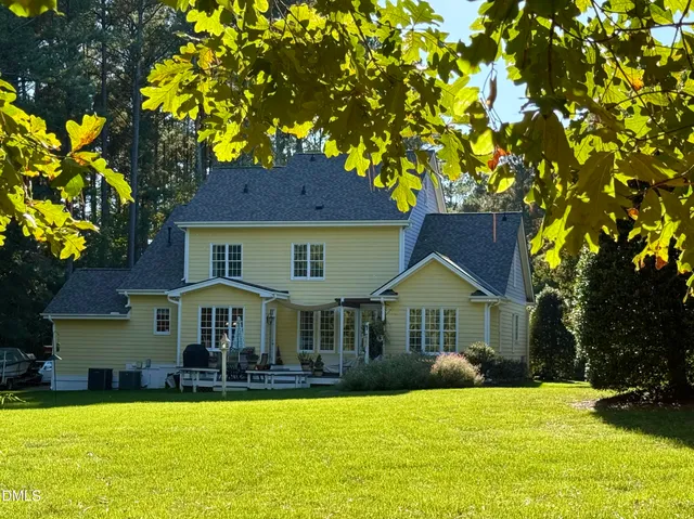 a front view of a house with swimming pool having outdoor seating