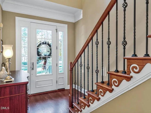 a view of an entryway with wooden floor and front door