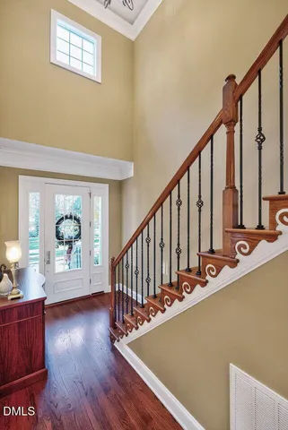 a view of a hallway with wooden floor and stairs