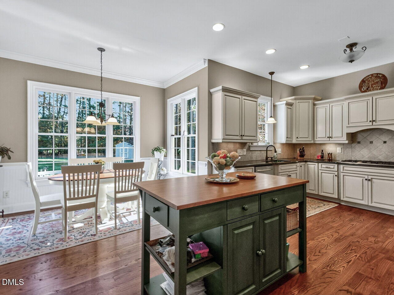 10312 Old Creedmoor Road Raleigh, NC 27613 - Photo 10 of 40 a kitchen with a stove a sink and a wooden floors