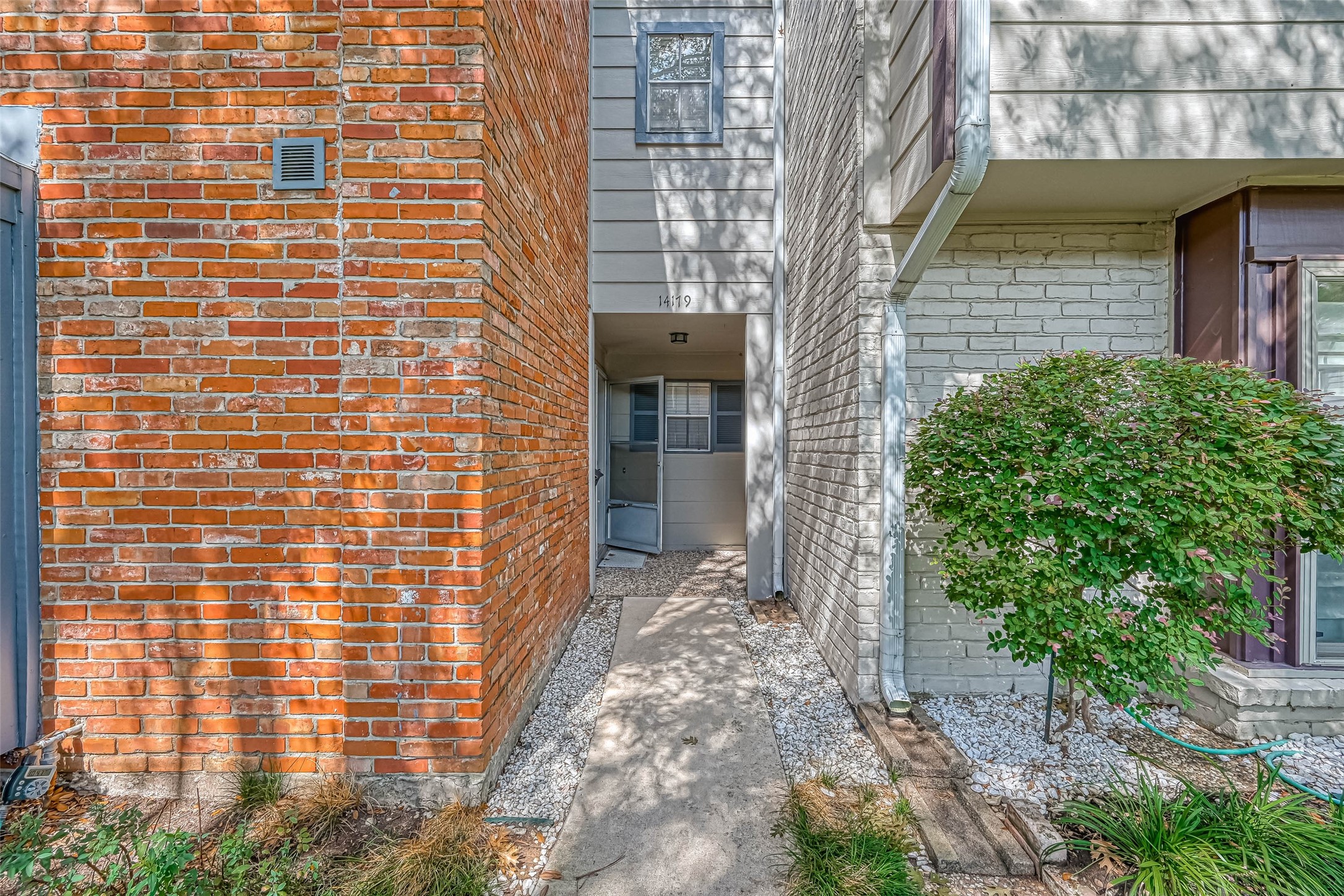 14179 Misty Meadow Lane Houston, TX 77079 - Photo 7 of 41 a view of a brick house with a large windows