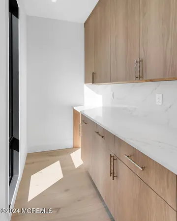 a view of kitchen with furniture and refrigerator