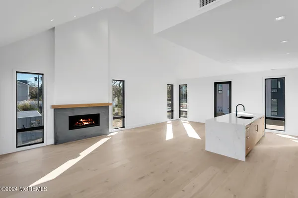 a hallway with a large window and kitchen view