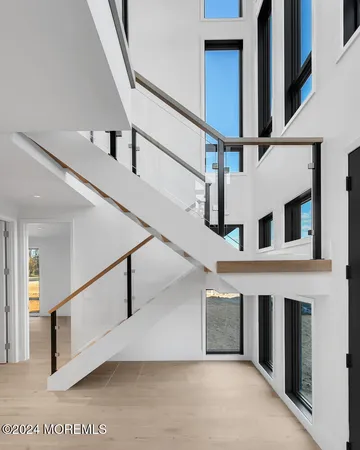 a view of a livingroom with furniture and staircase