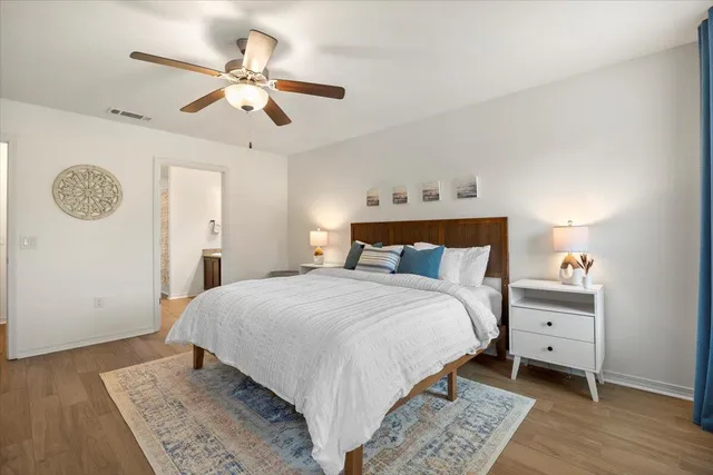 a bedroom with a large bed and a chandelier