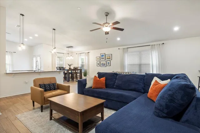 a living room with furniture and kitchen view