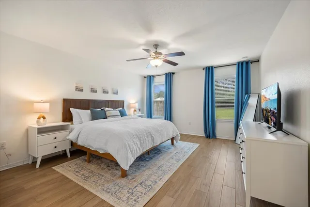 a bedroom with a bed and a flat screen tv