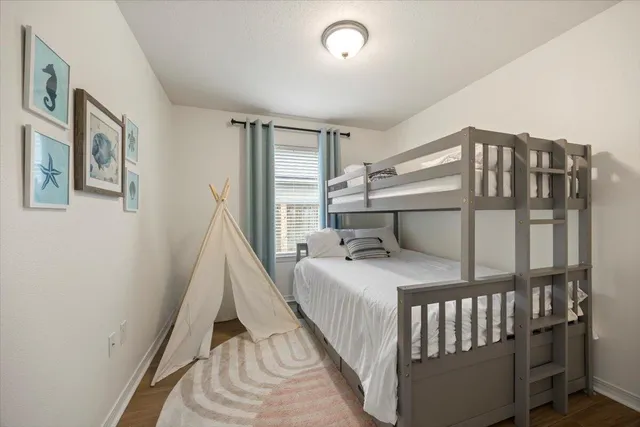 a bedroom with a bed next to a large window