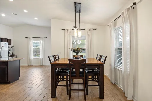 a view of a dining room with furniture window and wooden floor