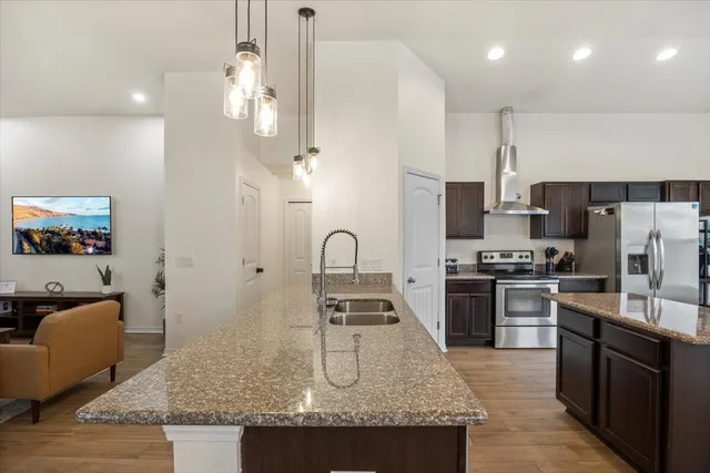 a kitchen with granite countertop stainless steel appliances and wooden cabinets