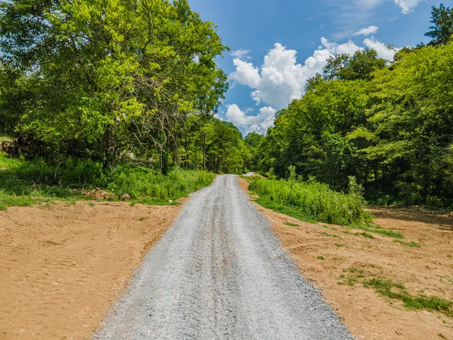 a view of a street with a yard